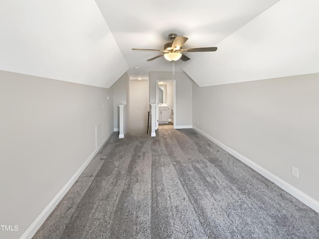 additional living space with visible vents, baseboards, ceiling fan, vaulted ceiling, and carpet floors