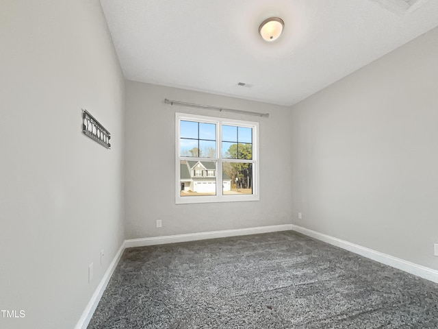 carpeted spare room featuring visible vents and baseboards