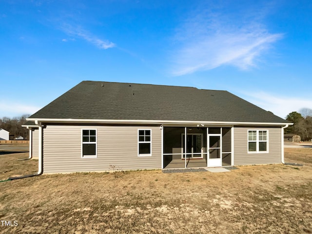 back of house featuring a sunroom and a shingled roof