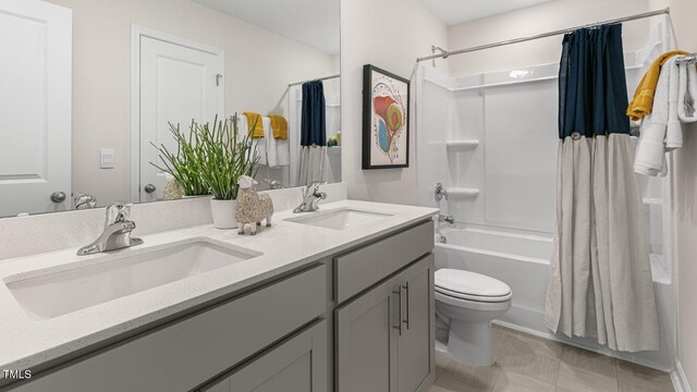 262 Hartfield Ave, Raeford, NC 28376 - bathroom featuring toilet, double vanity, shower / bath combo with shower curtain, and a sink