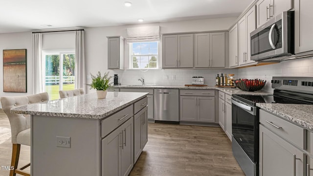 262 Hartfield Ave, Raeford, NC 28376 - kitchen featuring a kitchen bar, appliances with stainless steel finishes, and gray cabinets