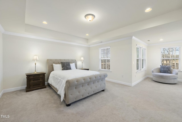 bedroom featuring a tray ceiling, ornamental molding, baseboards, and light carpet