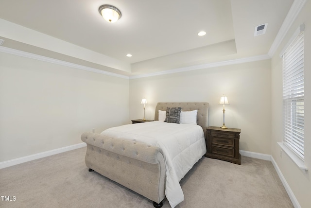 bedroom featuring light carpet, visible vents, baseboards, and a tray ceiling