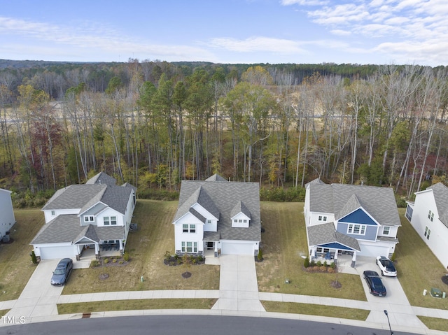 birds eye view of property with a wooded view