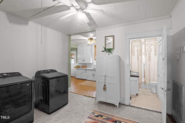 washroom featuring attic access, independent washer and dryer, crown molding, and laundry area