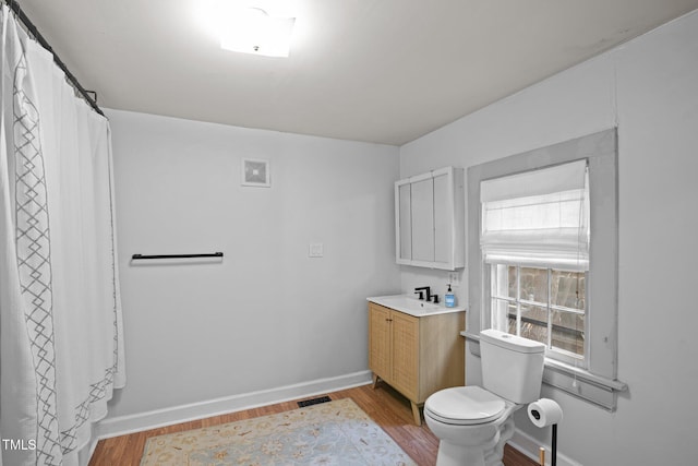 full bath featuring baseboards, vanity, toilet, and wood finished floors