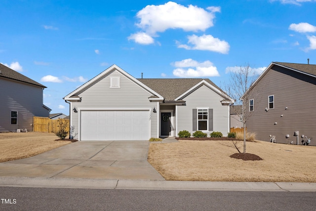 single story home with concrete driveway, an attached garage, and fence