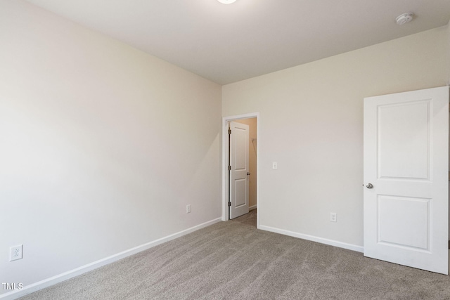 carpeted spare room with baseboards