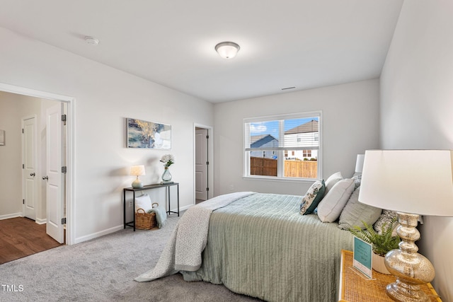 bedroom with carpet flooring and baseboards