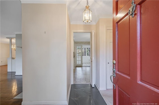 foyer featuring ornamental molding and baseboards