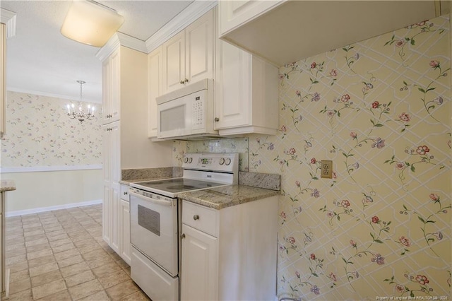 kitchen with a wainscoted wall, ornamental molding, a chandelier, white appliances, and wallpapered walls