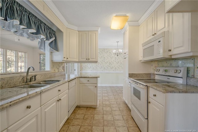 kitchen featuring ornamental molding, white appliances, a sink, and light stone counters