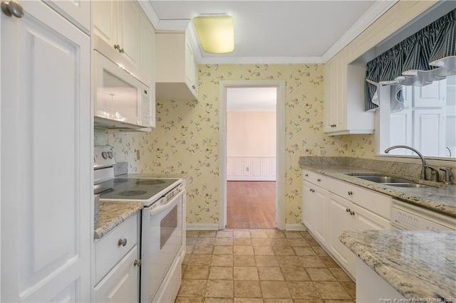 kitchen with crown molding, white appliances, a sink, and wallpapered walls