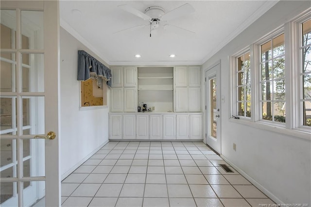 unfurnished sunroom with a ceiling fan and visible vents