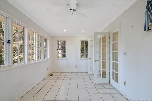 unfurnished sunroom with ceiling fan and french doors