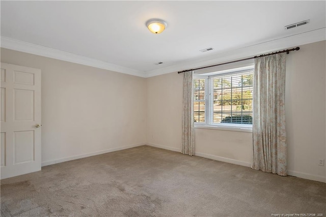 spare room with baseboards, visible vents, crown molding, and carpet flooring