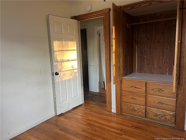 interior space with baseboards and wood finished floors