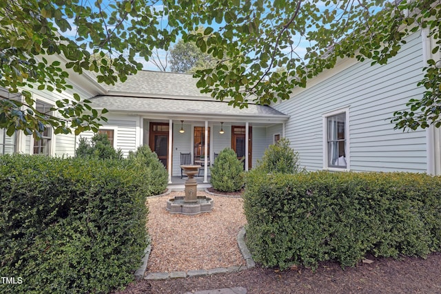 view of front of property featuring a porch and roof with shingles