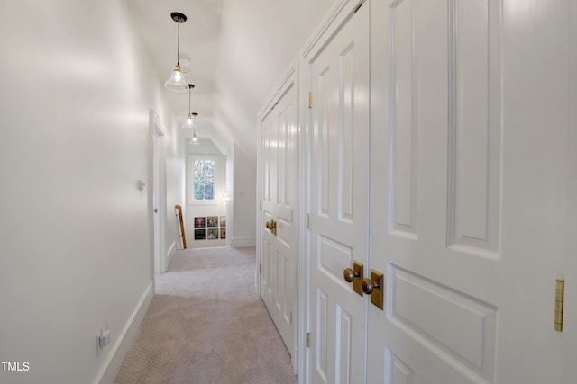 hall with light carpet and baseboards