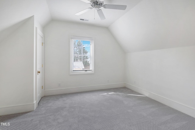 additional living space featuring lofted ceiling, ceiling fan, visible vents, baseboards, and carpet