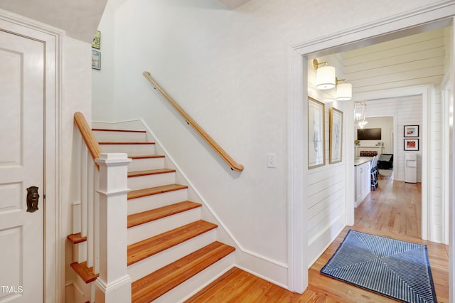 stairs featuring baseboards and wood finished floors