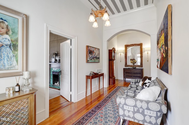 hallway featuring a notable chandelier and wood finished floors