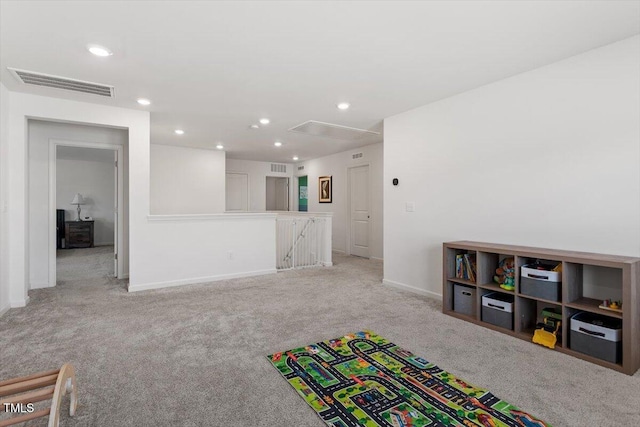 recreation room featuring attic access, visible vents, baseboards, light colored carpet, and recessed lighting