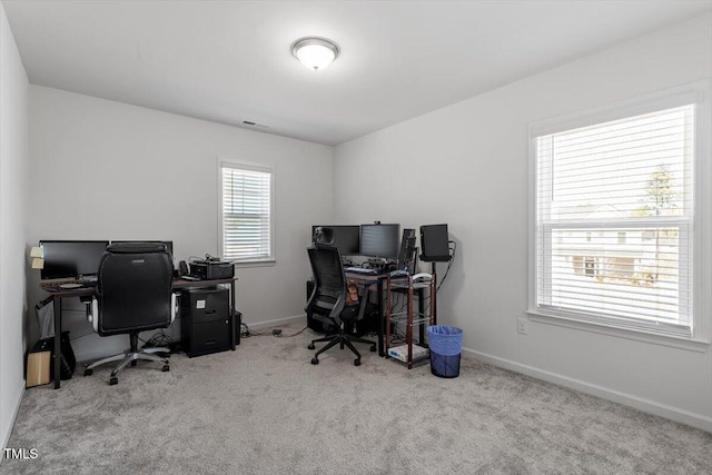 carpeted office with visible vents and baseboards