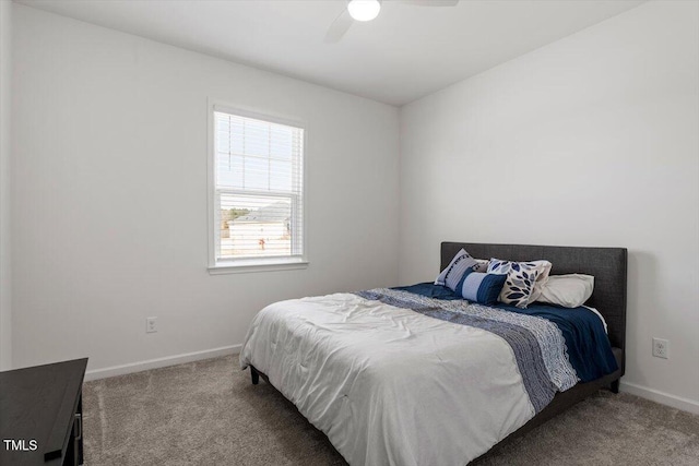 carpeted bedroom with baseboards and a ceiling fan