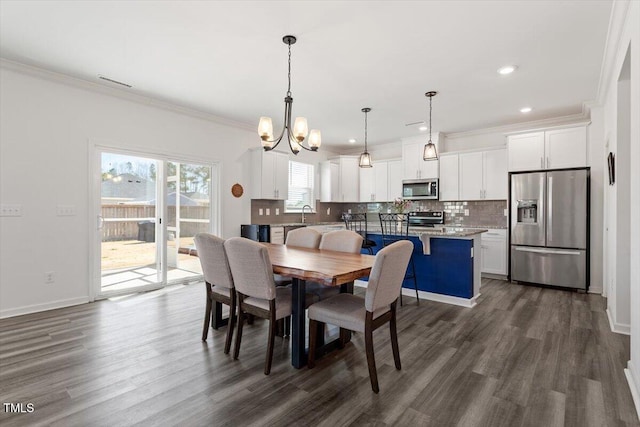 dining area with baseboards, dark wood finished floors, ornamental molding, a notable chandelier, and recessed lighting