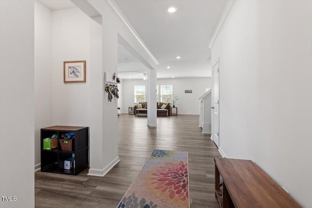 hall with dark wood-style floors, recessed lighting, crown molding, and baseboards