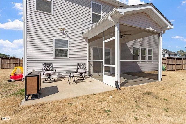 exterior space with a patio, a yard, fence, and a sunroom