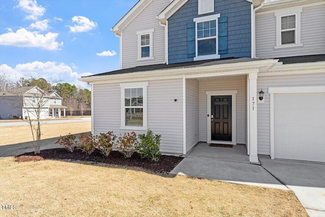 view of front of property with a garage and a front yard