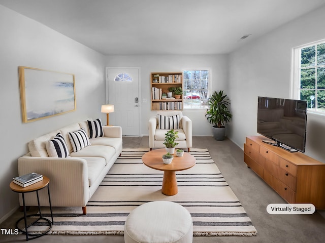 living area featuring visible vents and light colored carpet