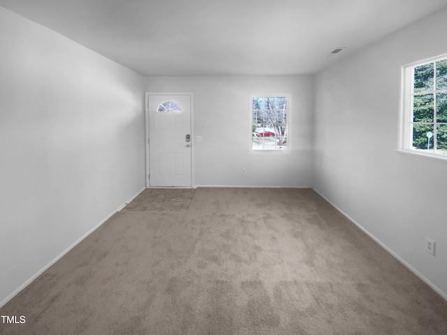 interior space featuring carpet flooring, visible vents, and baseboards