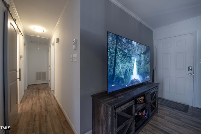 hall featuring attic access, visible vents, crown molding, and wood finished floors