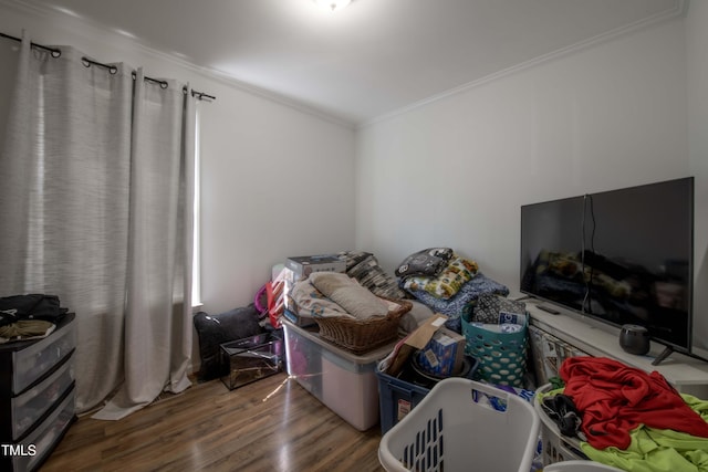 bedroom featuring wood finished floors and crown molding