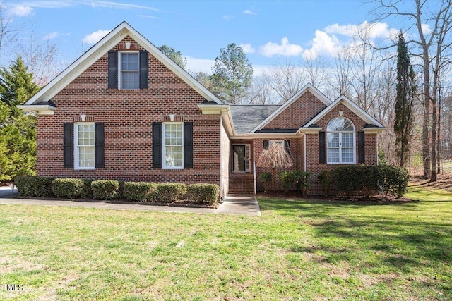 traditional-style home with brick siding and a front lawn