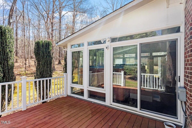 wooden deck with a sunroom