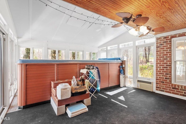 sunroom / solarium with lofted ceiling, plenty of natural light, and wooden ceiling