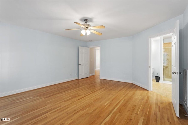 empty room with baseboards, a ceiling fan, and light wood-style floors