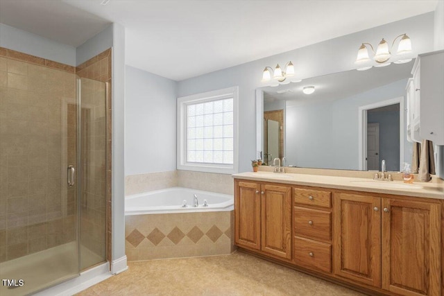 bathroom with double vanity, a garden tub, a shower stall, and a sink