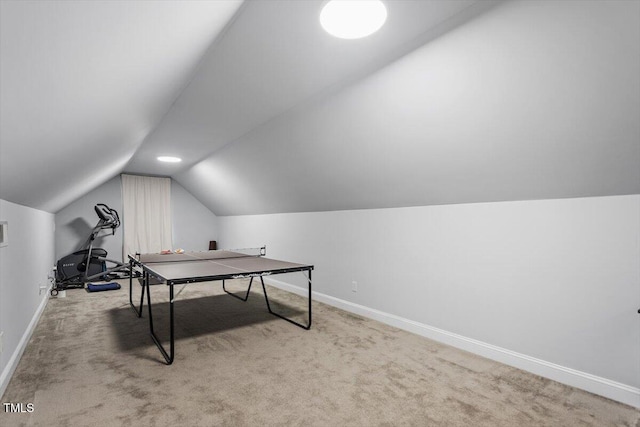 recreation room with carpet floors, vaulted ceiling, and baseboards