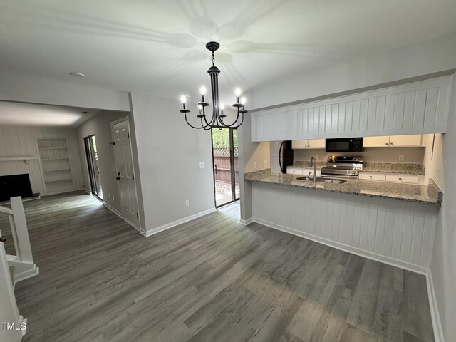 159 Finley Forest Dr, Chapel Hill, NC 27517 - kitchen featuring appliances with stainless steel finishes, a sink, a chandelier, wood finished floors, and white cabinetry