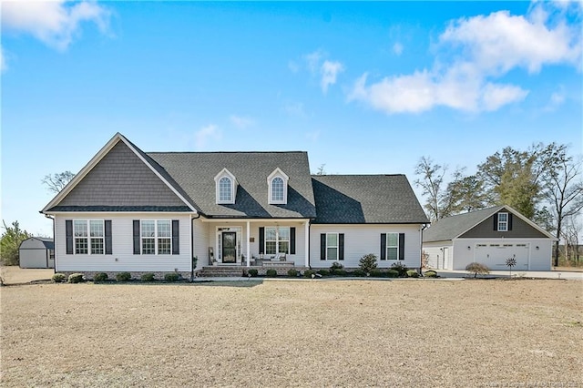 view of front of property with a garage and an outdoor structure