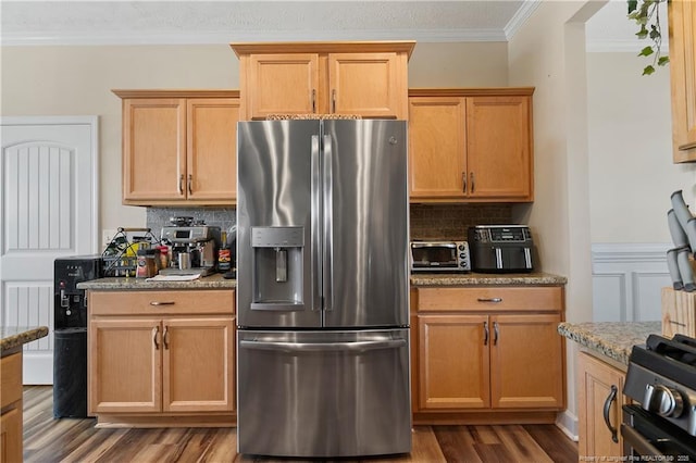 kitchen featuring light stone countertops, dark wood-style flooring, stainless steel refrigerator with ice dispenser, decorative backsplash, and crown molding