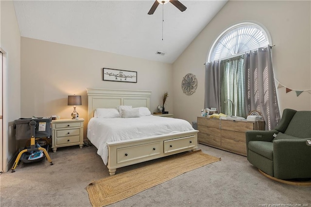 carpeted bedroom featuring a ceiling fan, visible vents, and high vaulted ceiling