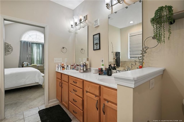 bathroom featuring double vanity, ensuite bath, a sink, and tile patterned floors