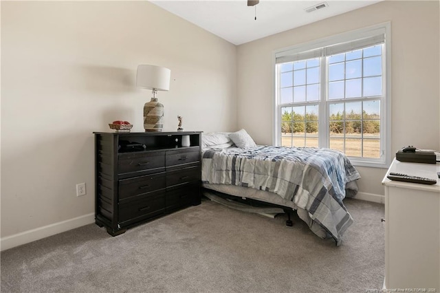 bedroom with light carpet, a ceiling fan, visible vents, and baseboards