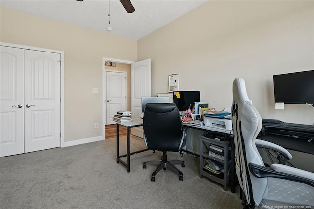 carpeted office featuring ceiling fan and baseboards